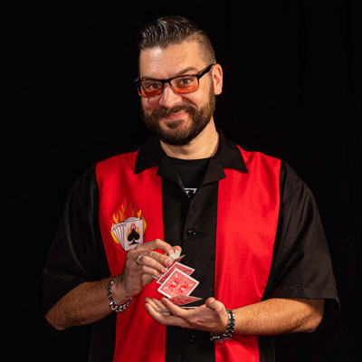 man in red black shirt with cards