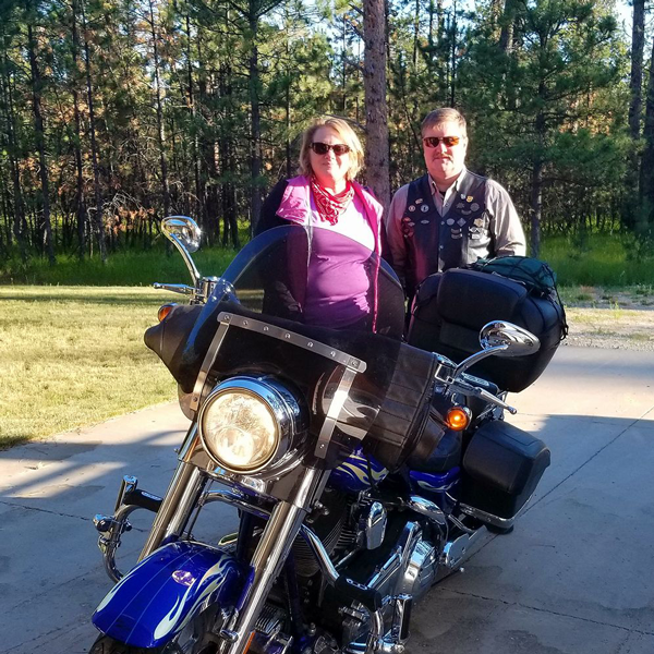 Kathleen Slocom with husband and motorcycle