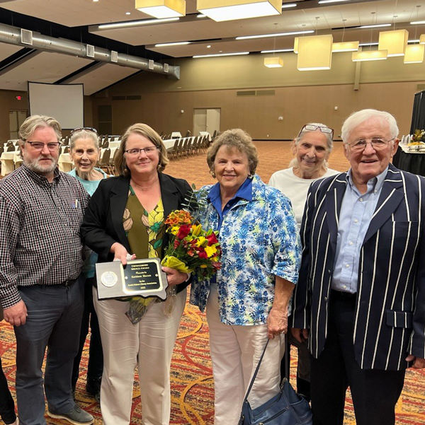 Kathleen Slocom with family presented with award at library conference