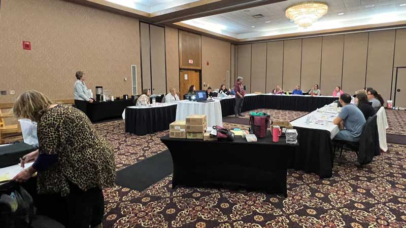 conference room with attendees and speakers