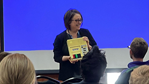 Michelle Loffelmacher holding up a tape cassette player from the 1980s.