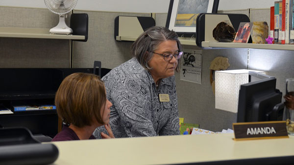 two women visiting over computer