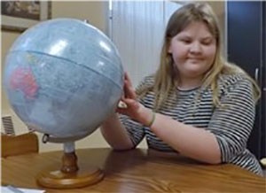 blond haired girl with globe
