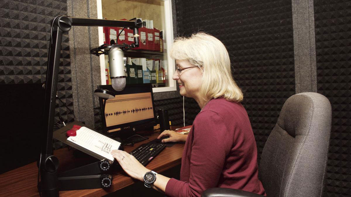 Volunteer Kathleen Bergeson using the new recording studio room in Vermillion Public Library