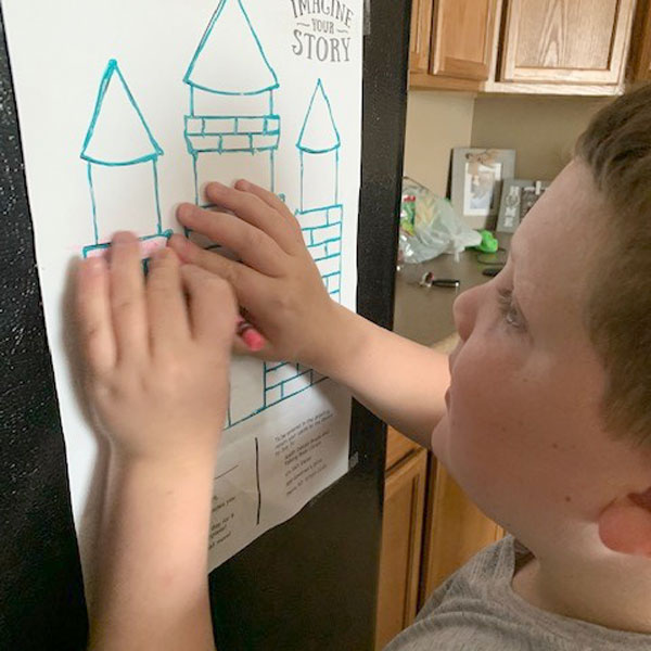 boy filling in castle blocks with crayon