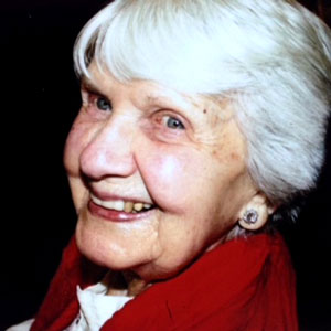 smiling woman with white hair, red jacket