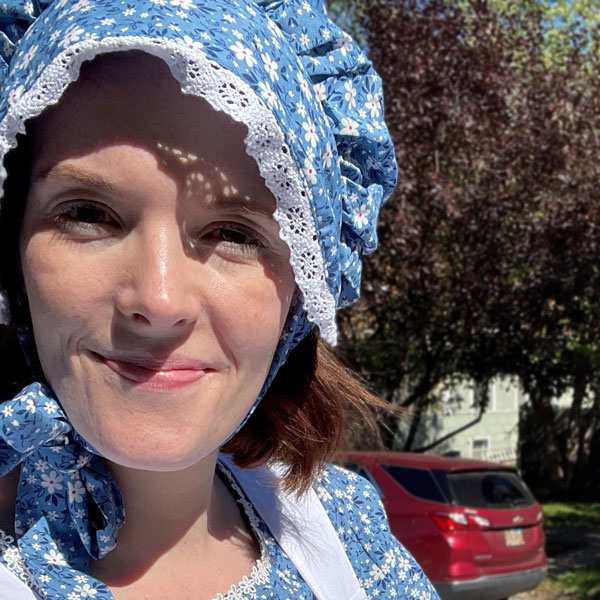 woman in blue bonnet and dress