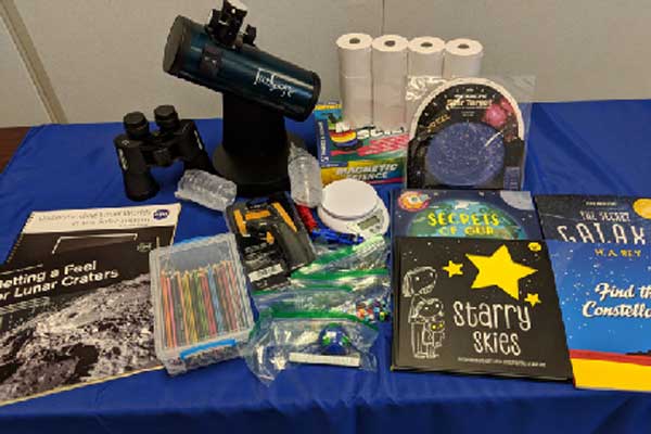 kit includes binoculars, Telescope, books, pencils, sensors, scale, magnets, and many more items