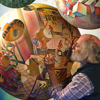 man painting sphere-shaped art