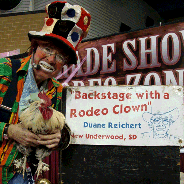 rodeo clown holding rooster