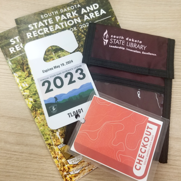 packet of south dakota state park and recreation area, 2023 park pass, check out, and south dakota state library neck wallet